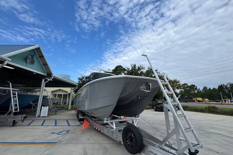 Slide: The Image of Invincible 40 Catamaran 2026 on trailer, parked outdoors under a partly cloudy sky. - 7
