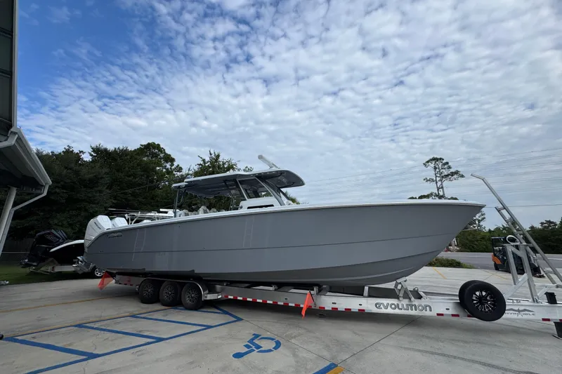 Slide: The Image of 2026 Invincible 40 Catamaran on trailer, parked outdoors under cloudy sky. - 9