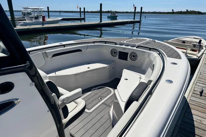 Slide: The Image of 2022 Tidewater 280 CC Adventure boat docked, featuring spacious seating and modern design. - 3