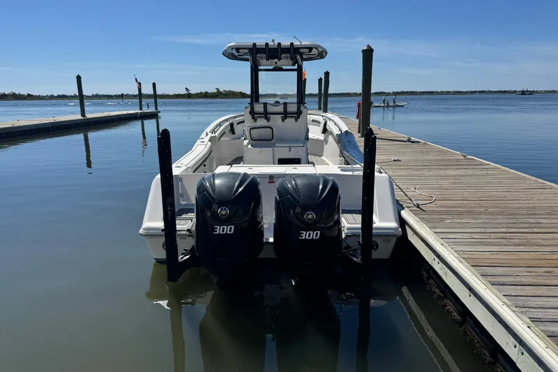 Slide: The Image of 2022 Tidewater 280 CC Adventure boat docked with twin 300 horsepower engines. - 8