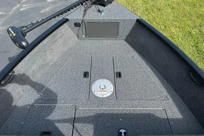 Slide: The Image of 2026 Lund 1650 Rebel XL Sport boat deck with trolling motor and storage compartments. - 11