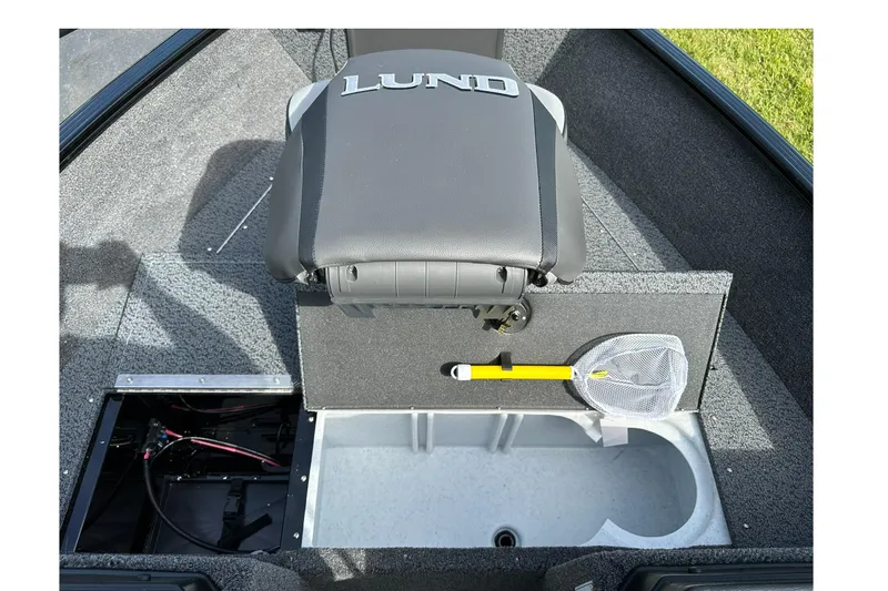 Slide: The Image of 2026 Lund 1650 Rebel XL Sport boat interior with storage compartments and fishing net. - 13