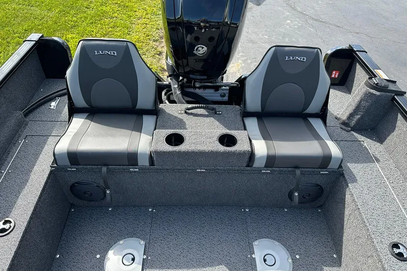 Slide: The Image of 2026 Lund 1650 Rebel XL Sport boat interior with dual seats and cup holders. - 14