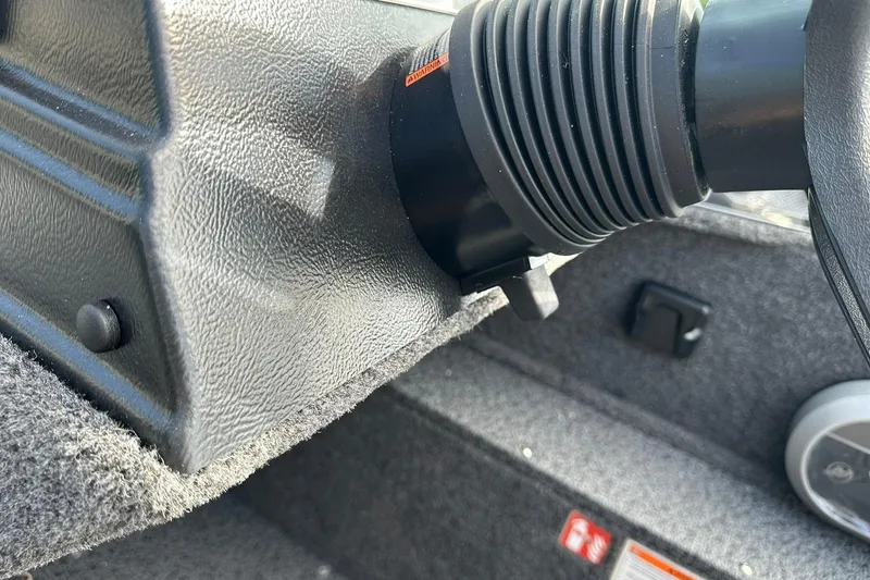 Slide: The Image of Close-up of 2026 Lund 1650 Rebel XL Sport boat interior, showing steering column details. - 25