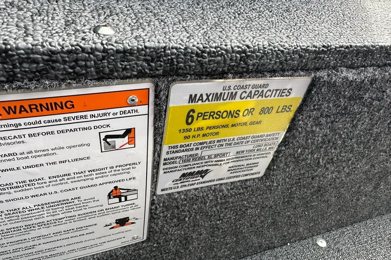 Slide: The Image of Warning and capacity labels on 2026 Lund 1650 Rebel XL Sport boat. - 26