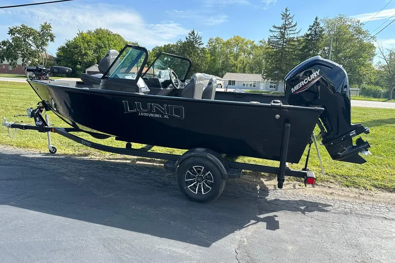 Slide: The Image of 2026 Lund 1650 Rebel XL Sport boat with Mercury engine on trailer. - 3