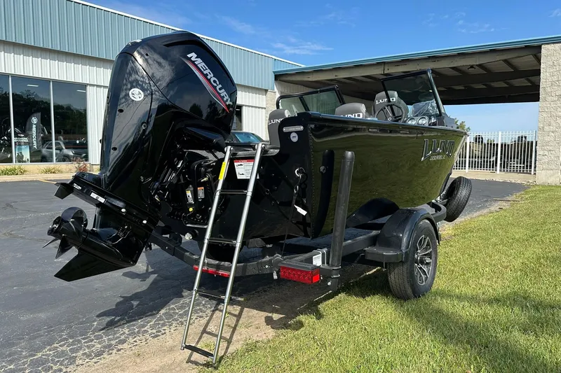 Slide: The Image of 2026 Lund 1650 Rebel XL Sport boat with Mercury outboard motor on trailer. - 4