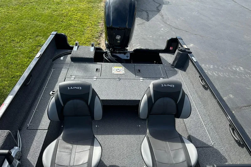 Slide: The Image of 2026 Lund 1650 Rebel XL Sport boat interior with two seats and motor. - 9