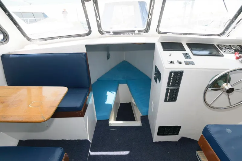 Slide: The Image of Interior of a 1997 Evans 36 Deadrise boat with seating and control panel. - 13