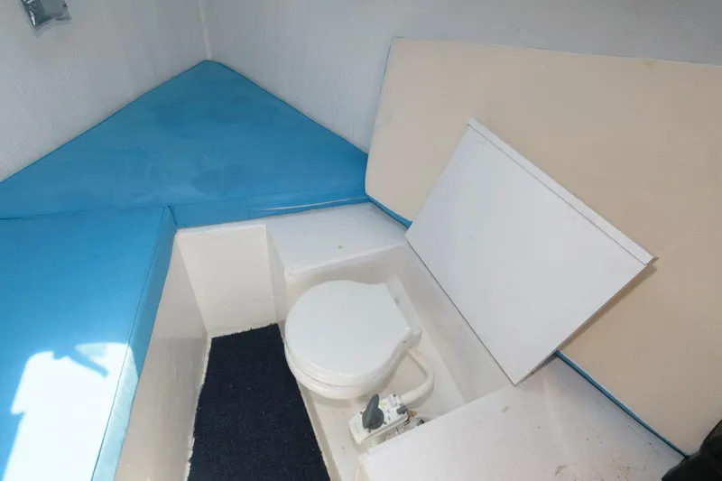 Slide: The Image of Interior of 1997 Evans 36 Deadrise boat with toilet and blue seating. - 14