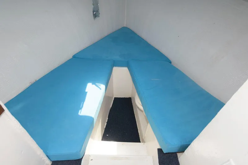 Slide: The Image of 1997 Evans 36 Deadrise boat interior with blue cushions and white walls. - 15