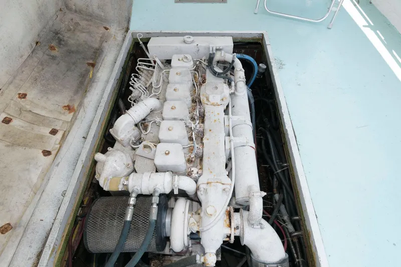 Slide: The Image of Engine compartment of a 1997 Evans 36 Deadrise boat, showcasing detailed mechanical components. - 17