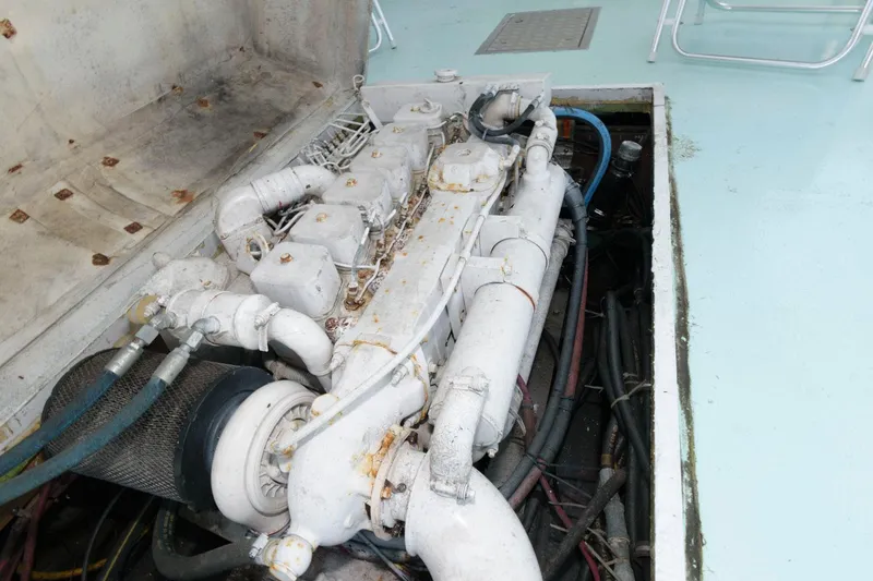 Slide: The Image of Engine compartment of a 1997 Evans 36 Deadrise boat, showcasing mechanical components. - 18