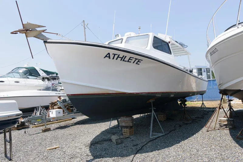 Slide: The Image of 1997 Evans 36 Deadrise boat named "Athlete" on dry dock, side view. - 2