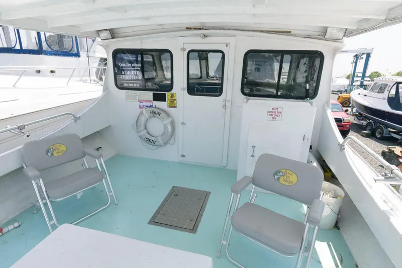 Slide: The Image of 1997 Evans 36 Deadrise boat deck with chairs and life preserver. - 3