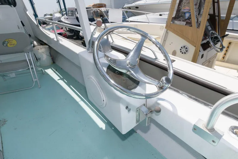 Slide: The Image of 1997 Evans 36 Deadrise boat steering wheel and cockpit area. - 7