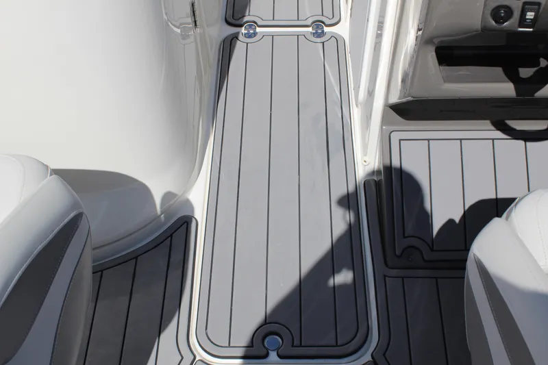 Slide: The Image of 2013 Rinker Captiva 246 BR boat interior with gray non-slip flooring. - 10