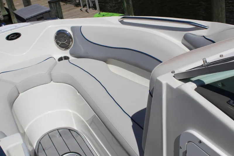 Slide: The Image of 2013 Rinker Captiva 246 BR boat interior with sleek seating and modern design. - 12
