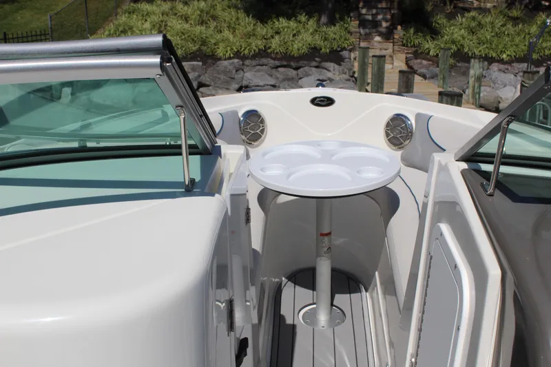 Slide: The Image of 2013 Rinker Captiva 246 BR boat interior with table and seating area. - 13