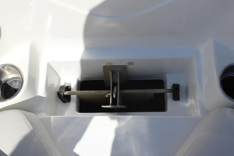 Slide: The Image of 2013 Rinker Captiva 246 BR boat anchor storage compartment with cup holders. - 14