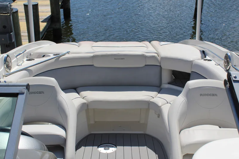 Slide: The Image of 2013 Rinker Captiva 246 BR boat interior with white seating and water view. - 2