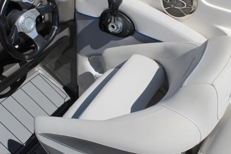 Slide: The Image of 2013 Rinker Captiva 246 BR boat interior with steering wheel and seating. - 4