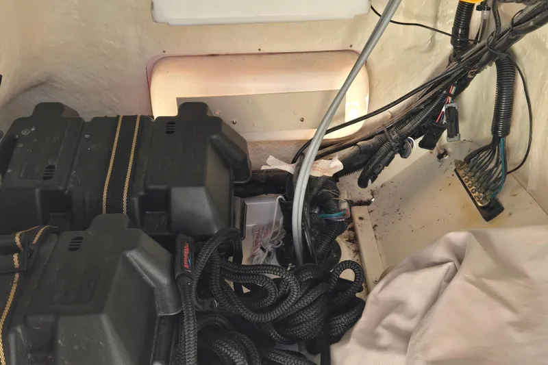 Slide: The Image of Interior view of a 2021 Boston Whaler 17MTK boat showing battery and wiring setup. - 10