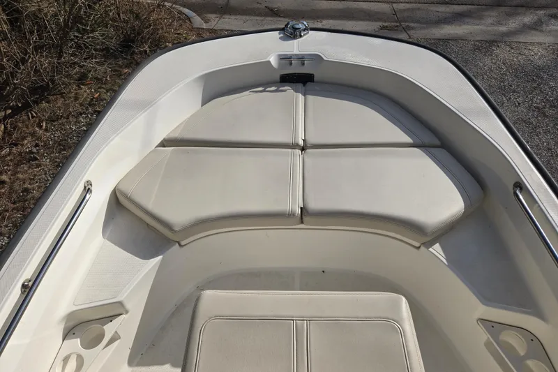 Slide: The Image of 2021 Boston Whaler 17MTK boat interior with cushioned seating and stainless steel railings. - 3