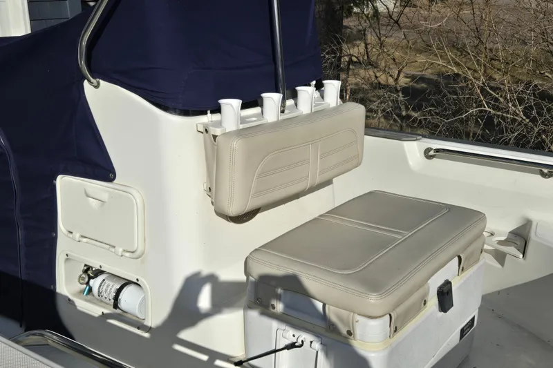 Slide: The Image of 2021 Boston Whaler 17MTK boat interior with cushioned seating and storage compartments. - 6
