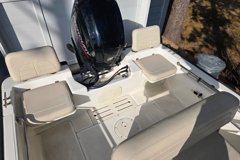 Slide: The Image of 2021 Boston Whaler 17MTK boat interior with Mercury engine and beige seating. - 8
