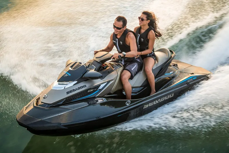 Slide: The Image of Manufacturer Provided Image: 2016 Sea-Doo GTX Limited 300 jet ski with two riders speeding on water. - 1