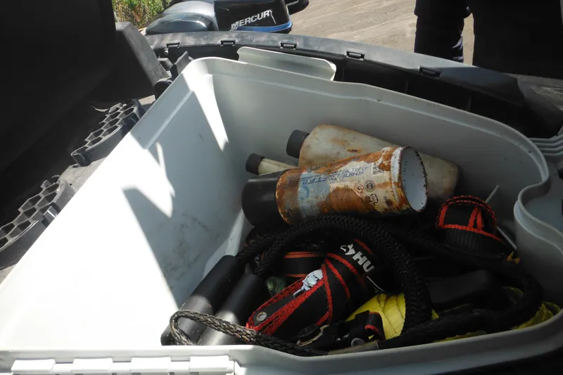 Slide: The Image of Open storage compartment of a 2016 Sea-Doo GTX Limited 300 with ropes and bottles. - 17