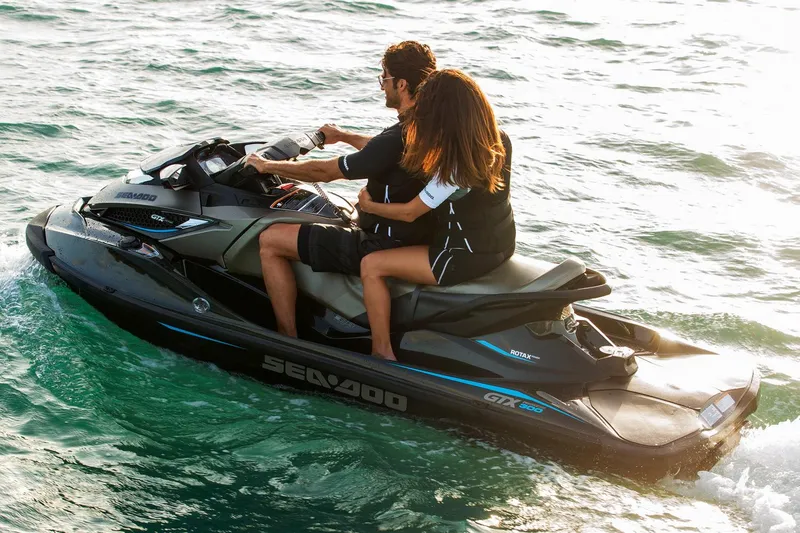 Slide: The Image of Manufacturer Provided Image: 2016 Sea-Doo GTX Limited 300 jet ski on water with two riders. - 2