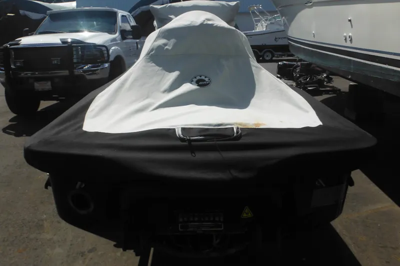 Slide: The Image of 2016 Sea-Doo GTX Limited 300 covered, parked beside vehicles and boats. - 4