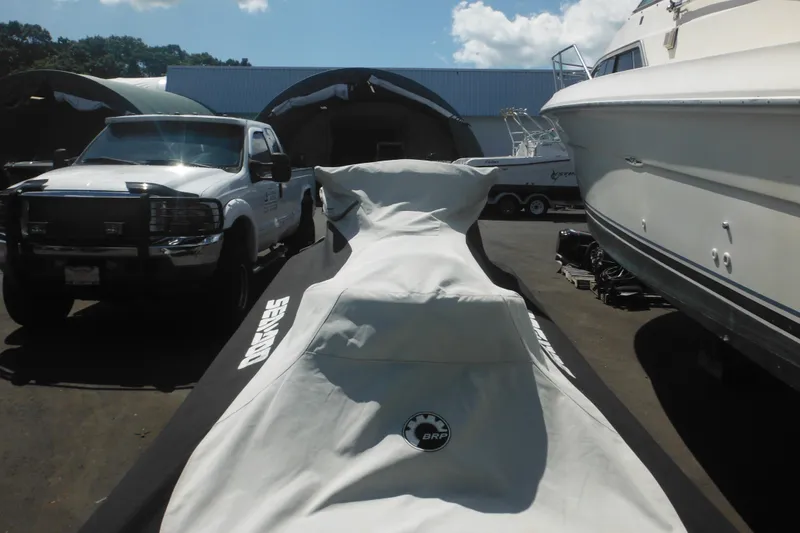 Slide: The Image of 2016 Sea-Doo GTX Limited 300 covered, parked between truck and boat. - 5