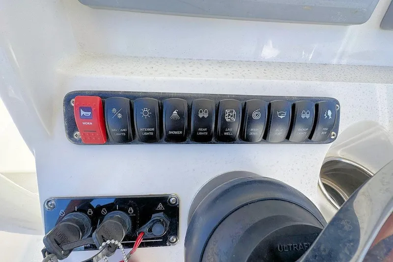 Slide: The Image of Control panel of a 2013 Sailfish 290 CC boat with labeled switches. - 10