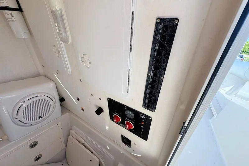 Slide: The Image of Interior view of 2013 Sailfish 290 CC boat, featuring control panel and speaker. - 13