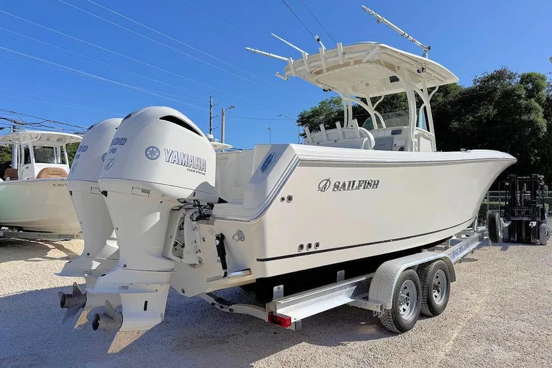 Slide: The Image of 2013 Sailfish 290 CC boat with twin Yamaha engines on a trailer. - 2
