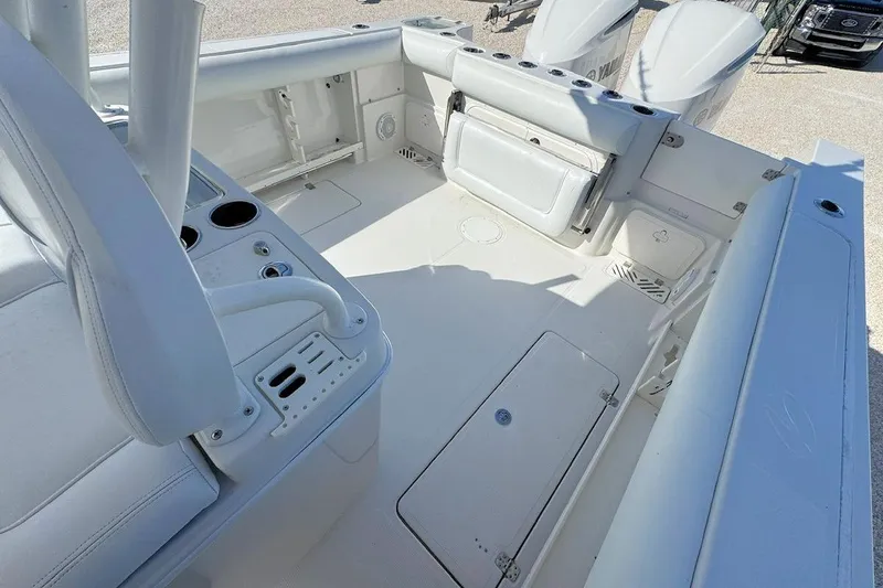 Slide: The Image of 2013 Sailfish 290 CC boat interior with seating and storage compartments. - 6