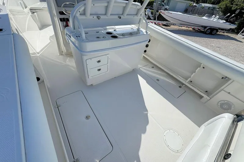 Slide: The Image of 2013 Sailfish 290 CC boat interior with storage compartments and seating. - 7