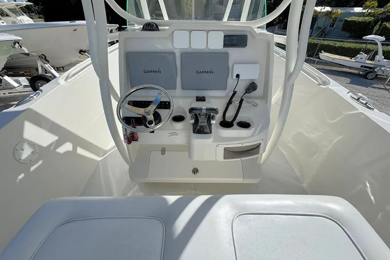 Slide: The Image of 2013 Sailfish 290 CC boat cockpit with Garmin navigation system and steering wheel. - 9