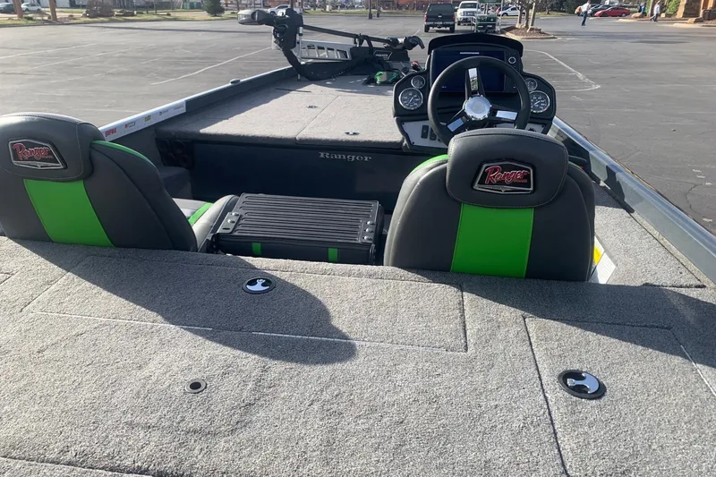 Slide: The Image of 2023 Ranger RT188 boat interior with green-accented seats and steering console. - 3