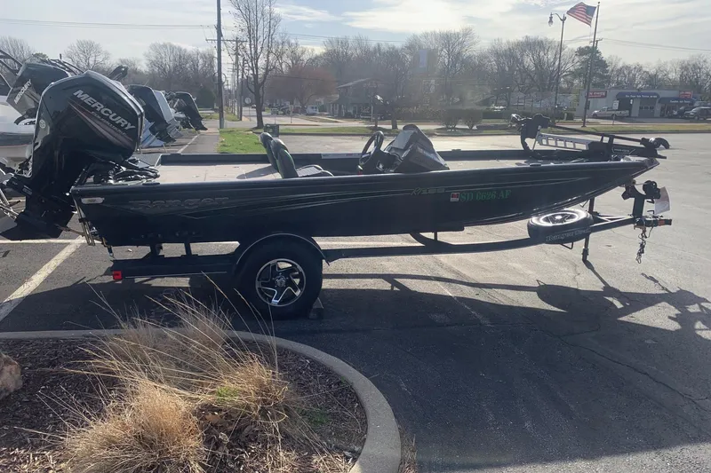 Slide: The Image of 2023 Ranger RT188 boat with Mercury engine on a trailer in a parking lot. - 4