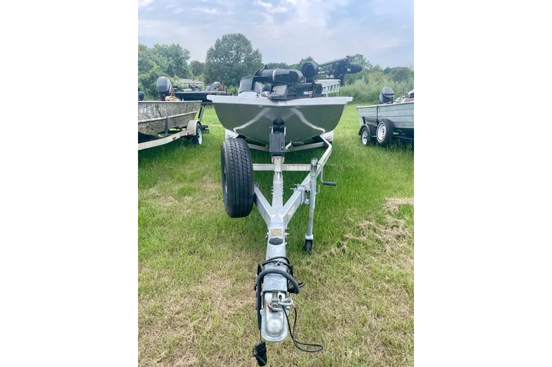 Slide: The Image of 2017 Xpress X21 boat on trailer, parked on grassy field. - 3