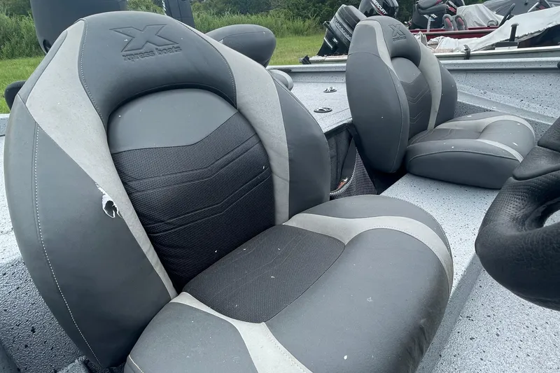 Slide: The Image of 2017 Xpress X21 boat seats with gray and black upholstery, showing minor wear. - 5