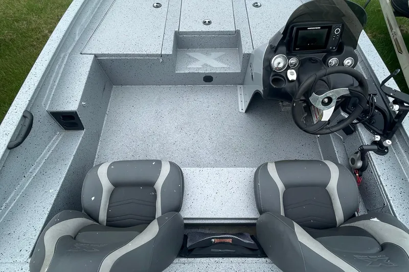 Slide: The Image of 2017 Xpress X21 boat interior with steering console and seating, featuring a sleek, modern design. - 6