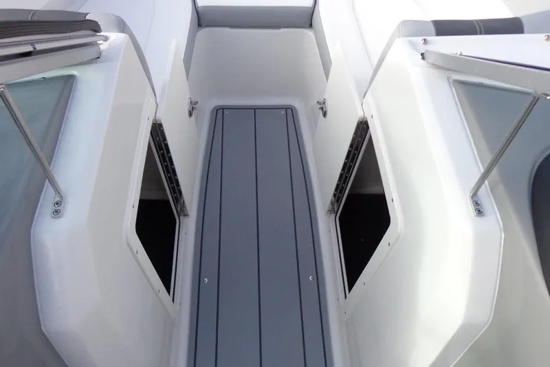 Slide: The Image of 2024 Chaparral 19 SSi OB boat interior with sleek, modern design and storage compartments. - 10