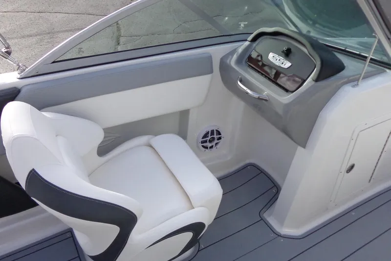 Slide: The Image of 2024 Chaparral 19 SSi OB boat interior with white seating and dashboard. - 14