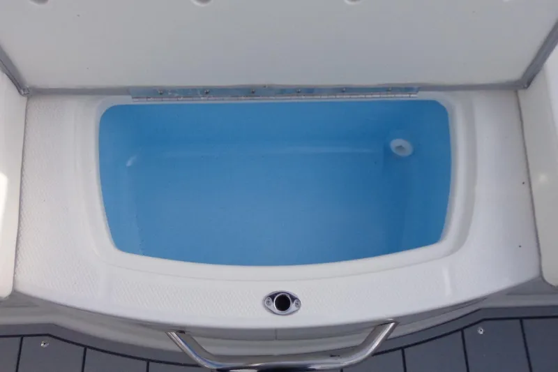 Slide: The Image of Livewell compartment on 2024 Chaparral 19 SSi OB boat, filled with water. - 18