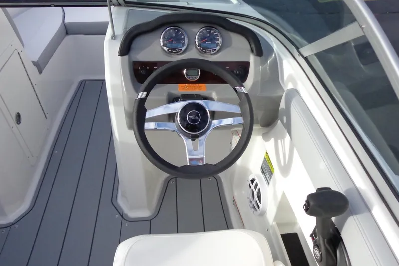 Slide: The Image of 2024 Chaparral 19 SSi OB boat cockpit with steering wheel and dashboard controls. - 6
